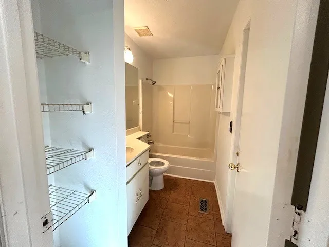 a bathroom with a bathtub shower sink and toilet