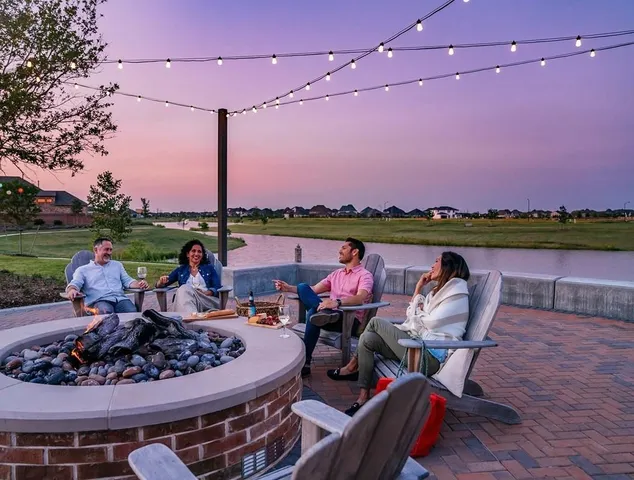 a view of a chairs and table in patio with a lake view