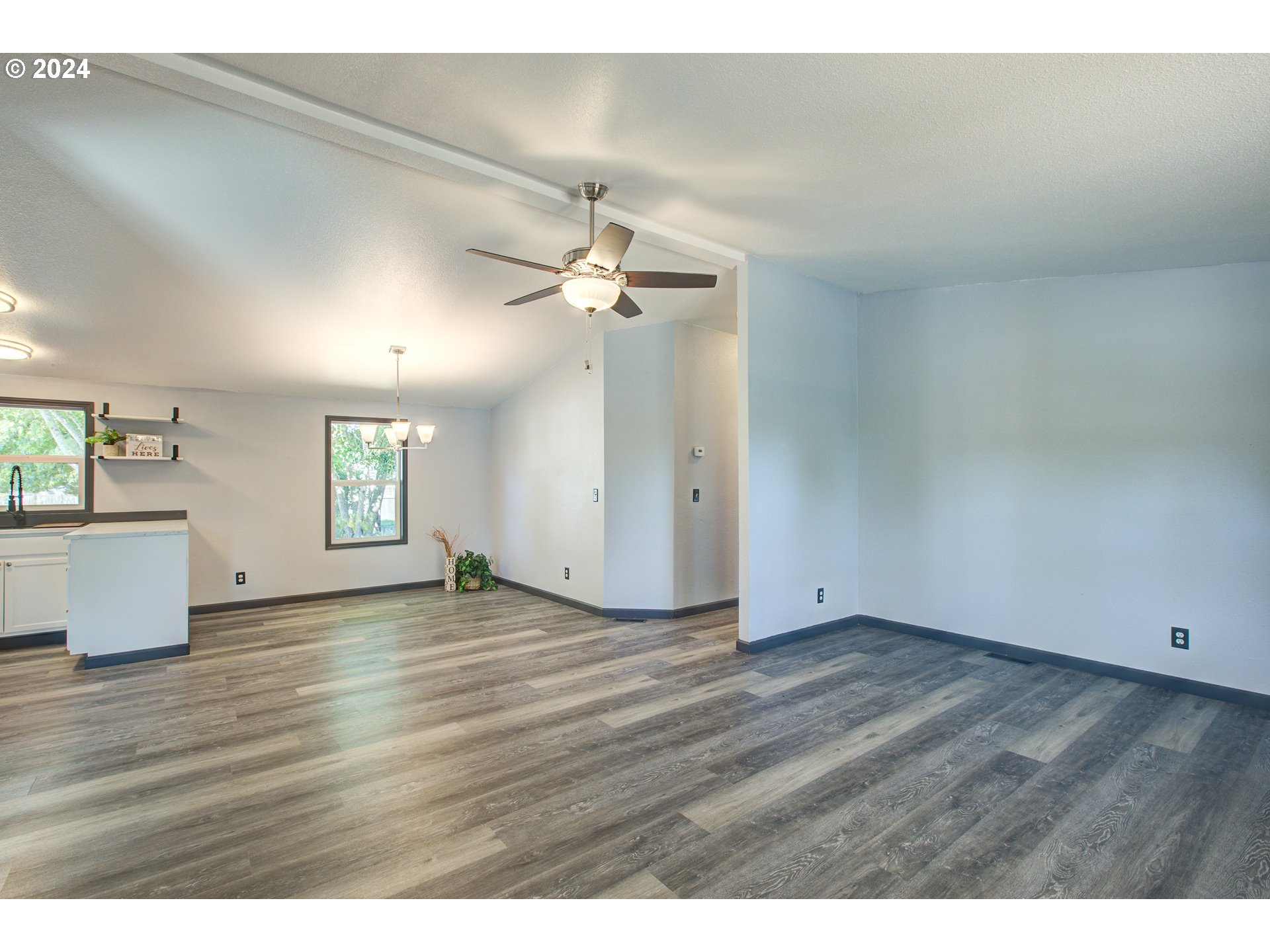 2438 Austin Road Roseburg, OR 97471 - Photo 11 of 48 an empty room with wooden floor and windows