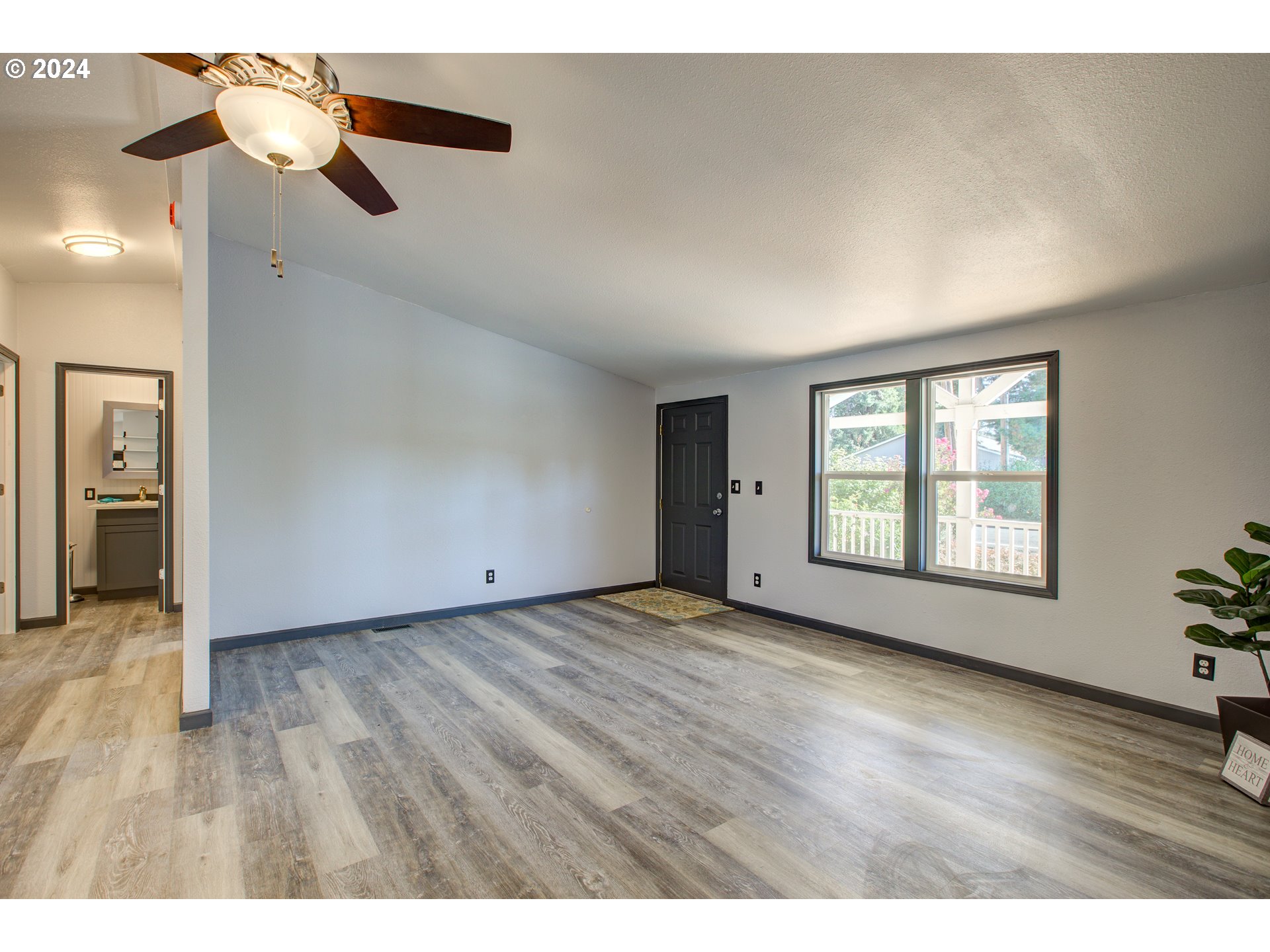 2438 Austin Road Roseburg, OR 97471 - Photo 12 of 48 a view of an empty room with wooden floor and windows