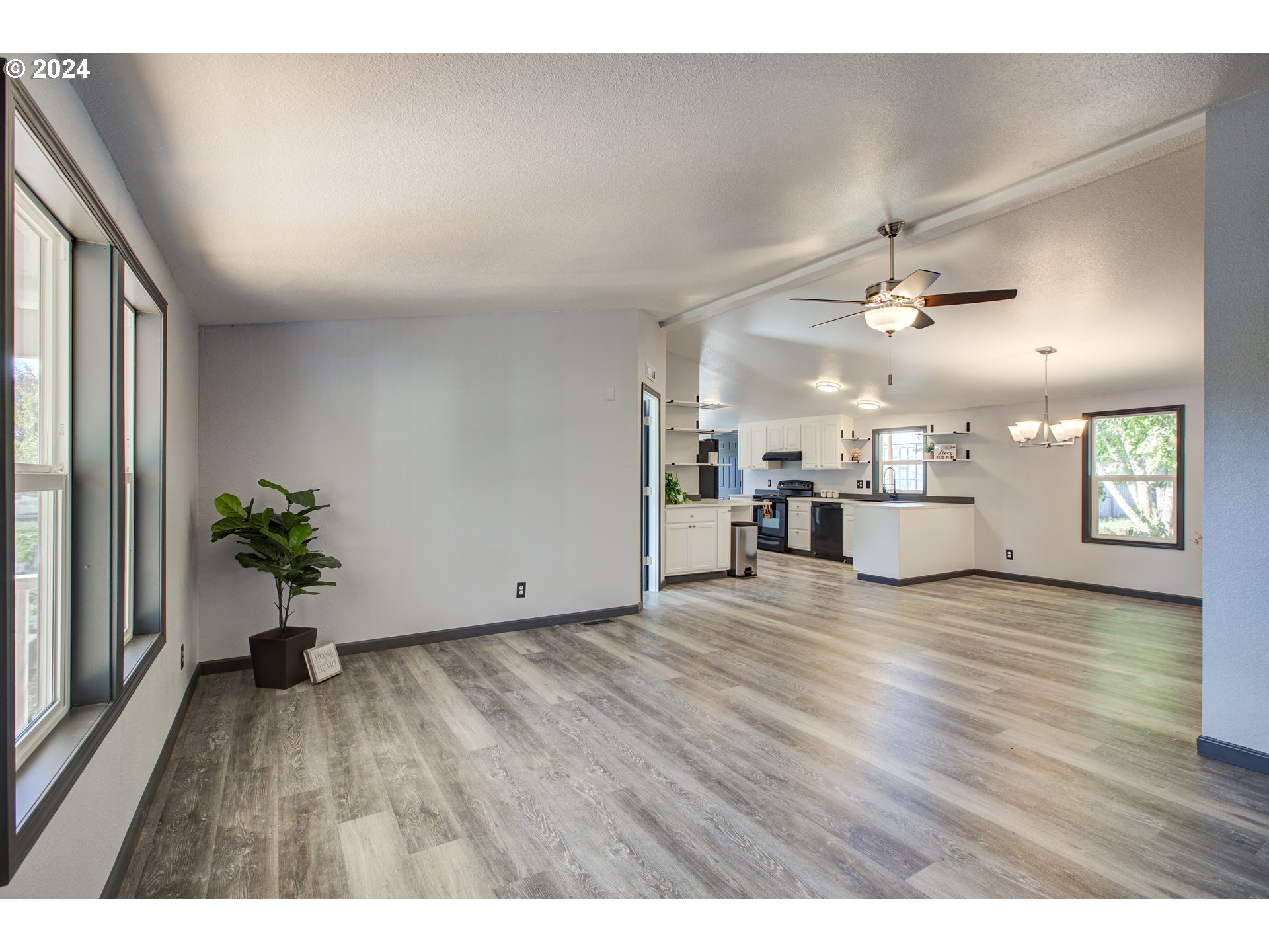 2438 Austin Road Roseburg, OR 97471 - Photo 13 of 48 an empty room with wooden floor and windows