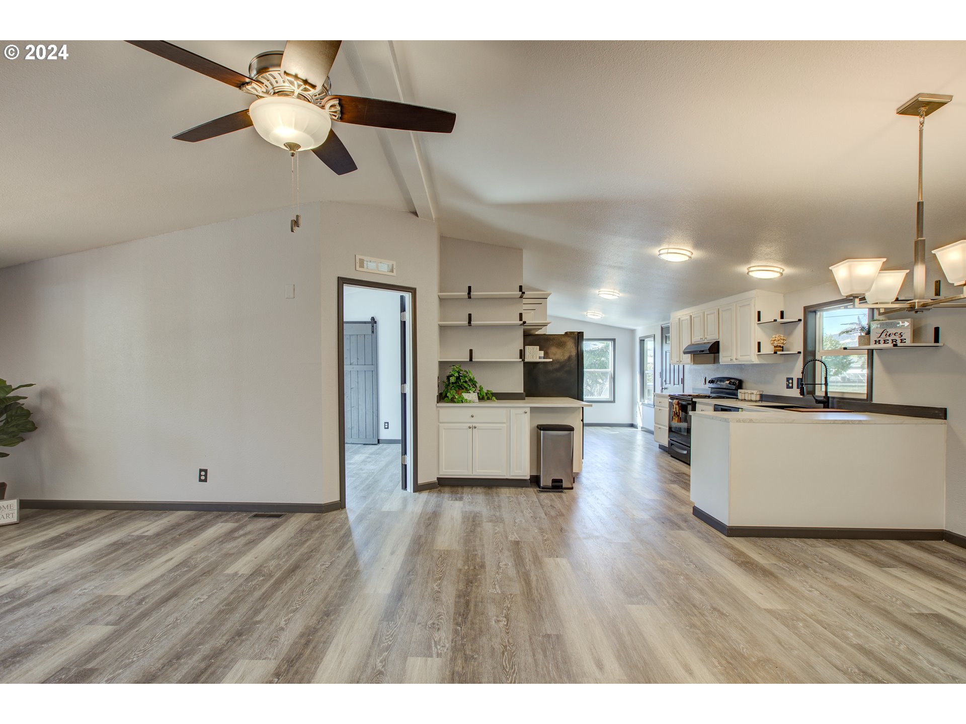 2438 Austin Road Roseburg, OR 97471 - Photo 14 of 48 a view of kitchen with microwave a refrigerator and wooden floor