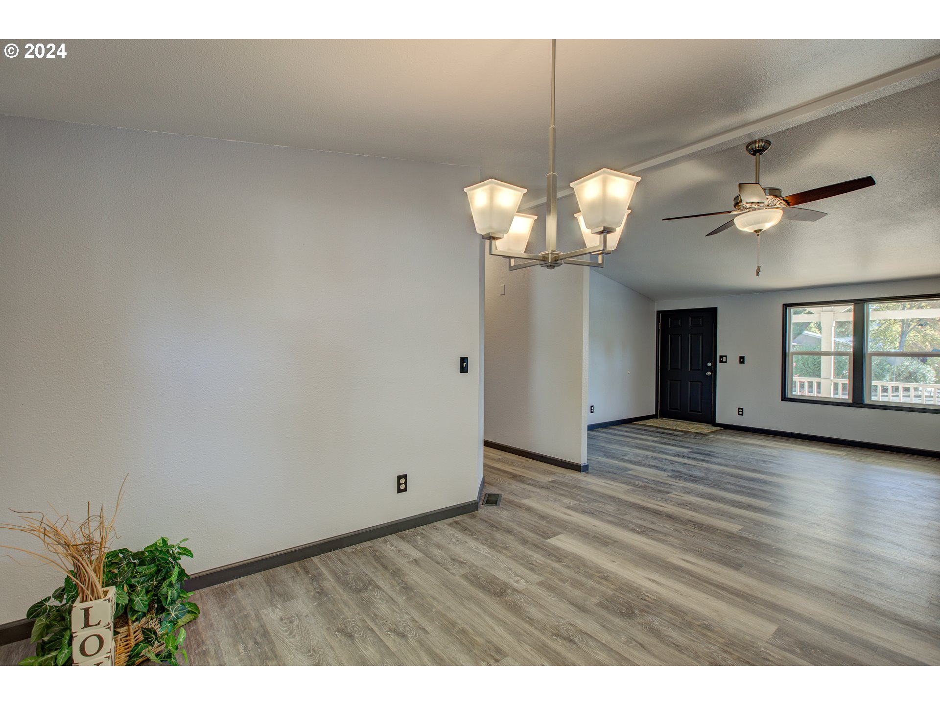 2438 Austin Road Roseburg, OR 97471 - Photo 16 of 48 a view of livingroom with chandelier fan and wooden floor