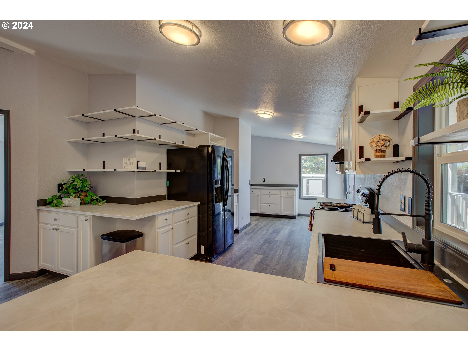 2438 Austin Road Roseburg, OR 97471 - Photo 18 of 48 a kitchen with kitchen island granite countertop a sink cabinets and wooden floor