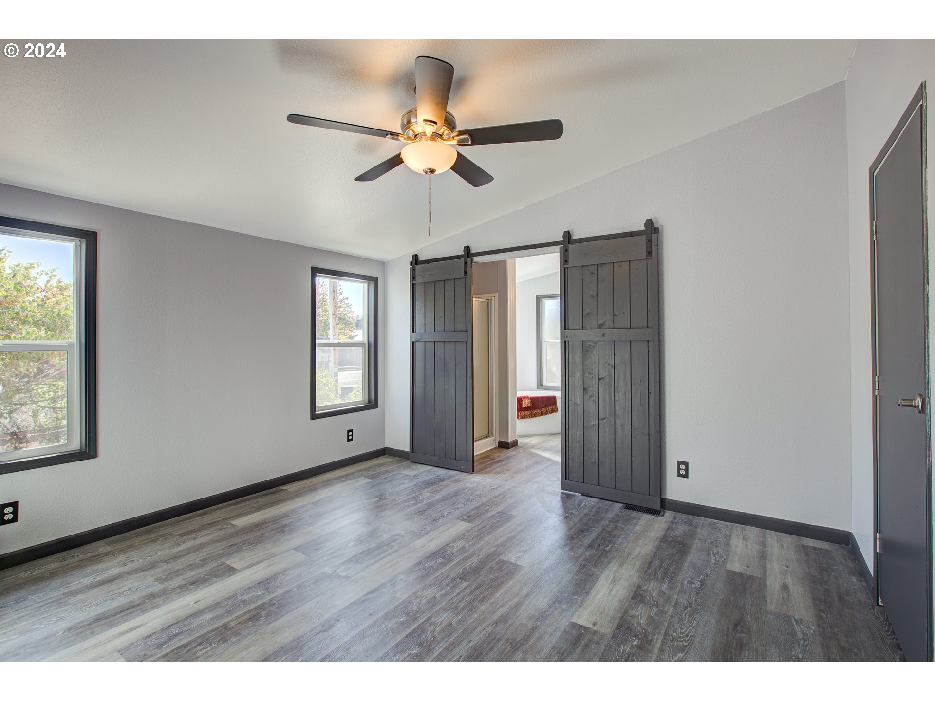 2438 Austin Road Roseburg, OR 97471 - Photo 25 of 48 a view of an empty room with wooden floor and a window