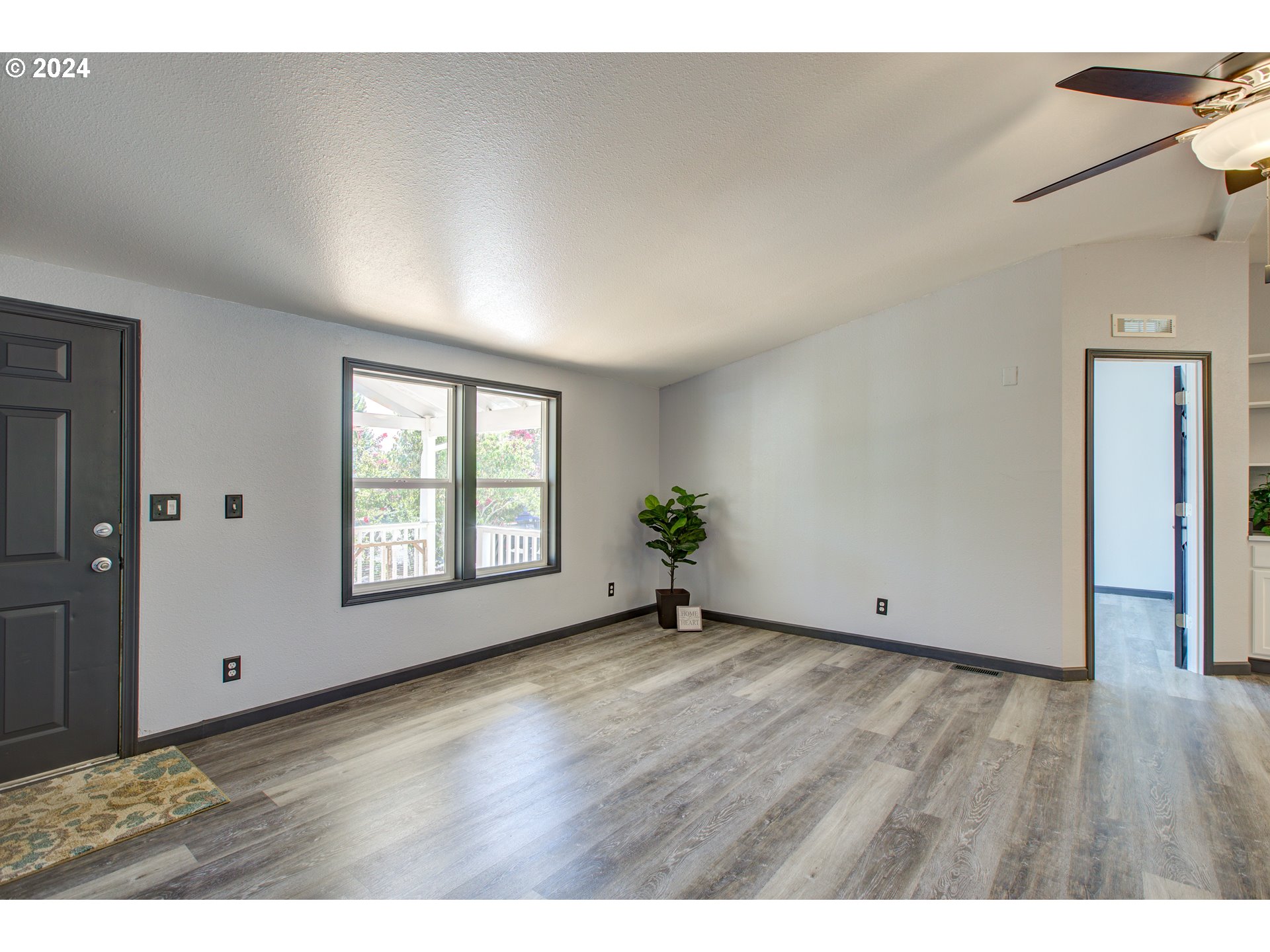 2438 Austin Road Roseburg, OR 97471 - Photo 8 of 48 a view of an empty room with wooden floor and a window