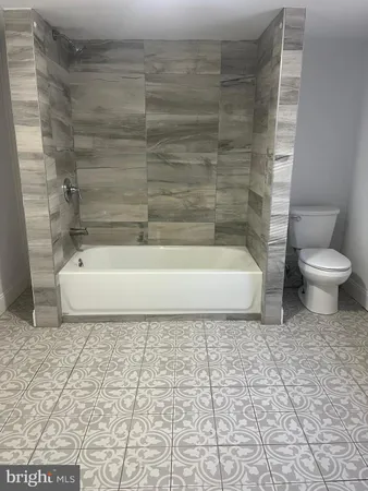 a bathroom with a white toilet and a shower