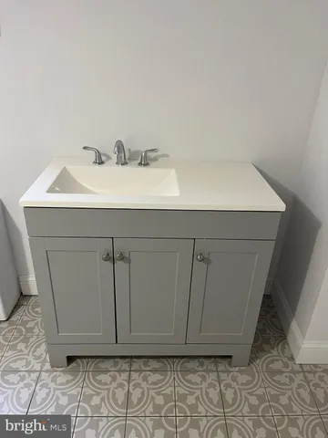 a bathroom with a sink and cabinets