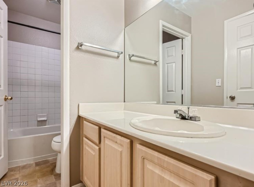 3950 South Sandhill Road, Unit 121 Las Vegas, NV 89121 - Photo 4 of 11 A well-appointed bathroom features a practical vanity and a tiled tub-shower combination.