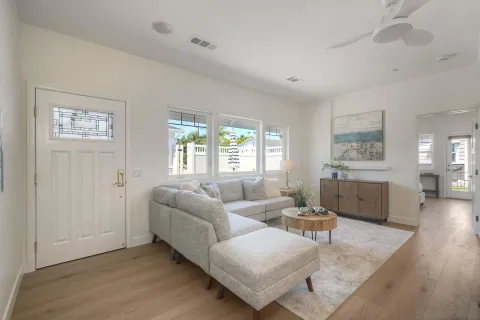 a living room with furniture and kitchen view