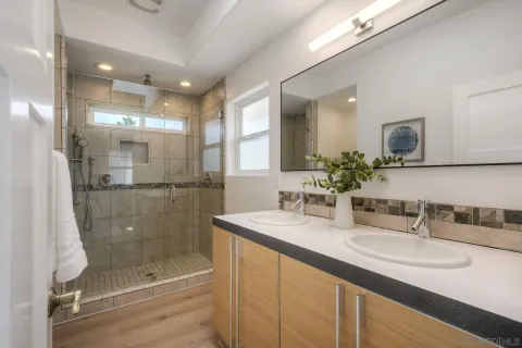 a bathroom with a granite countertop sink a toilet and bathtub