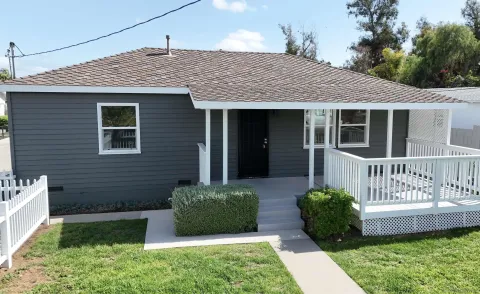 a view of a house with a yard and plants