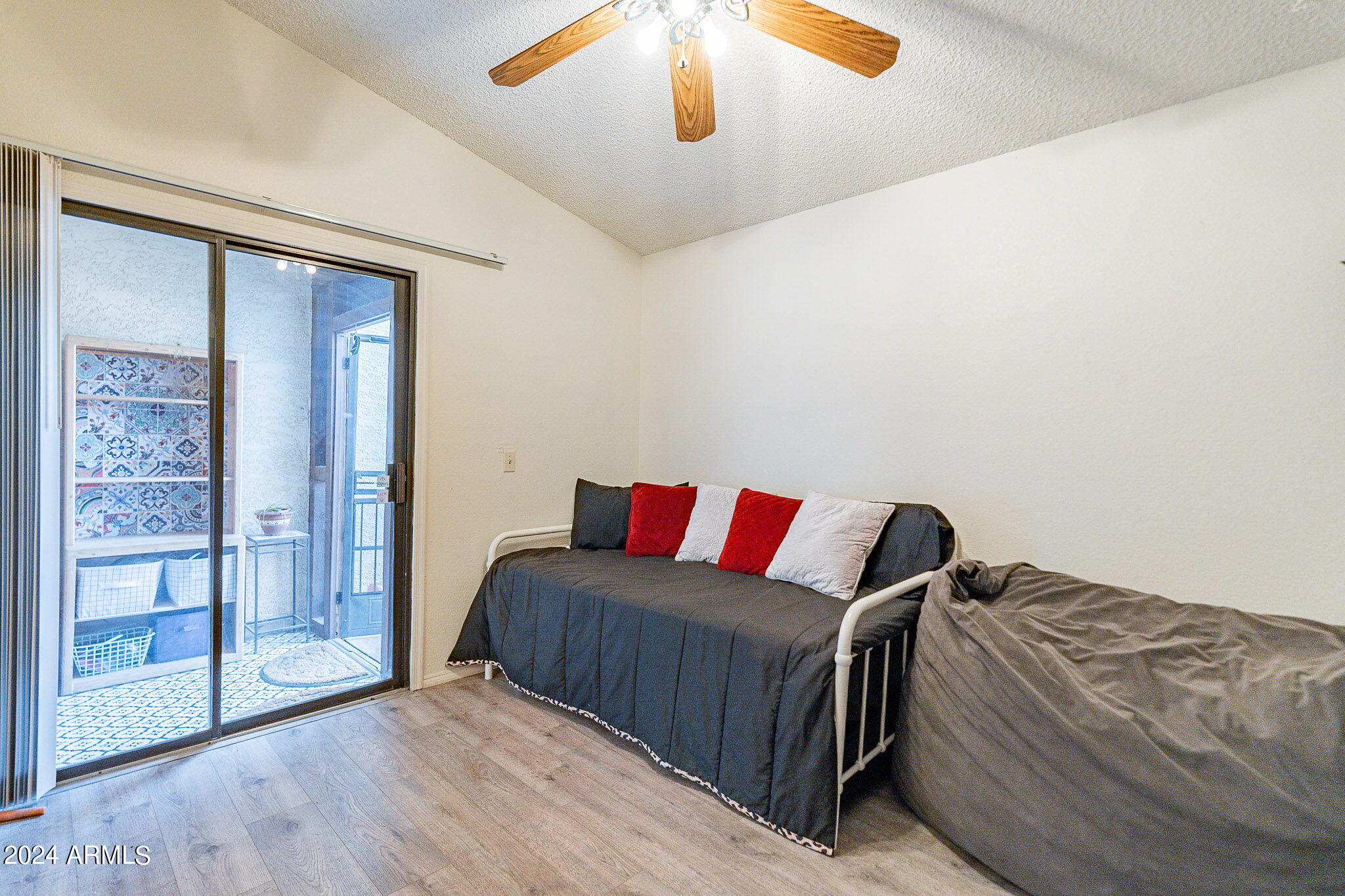 170 East Guadalupe Road, Unit 67 Gilbert, AZ 85234 - Photo 12 of 29 a bedroom with a large bed and a chandelier