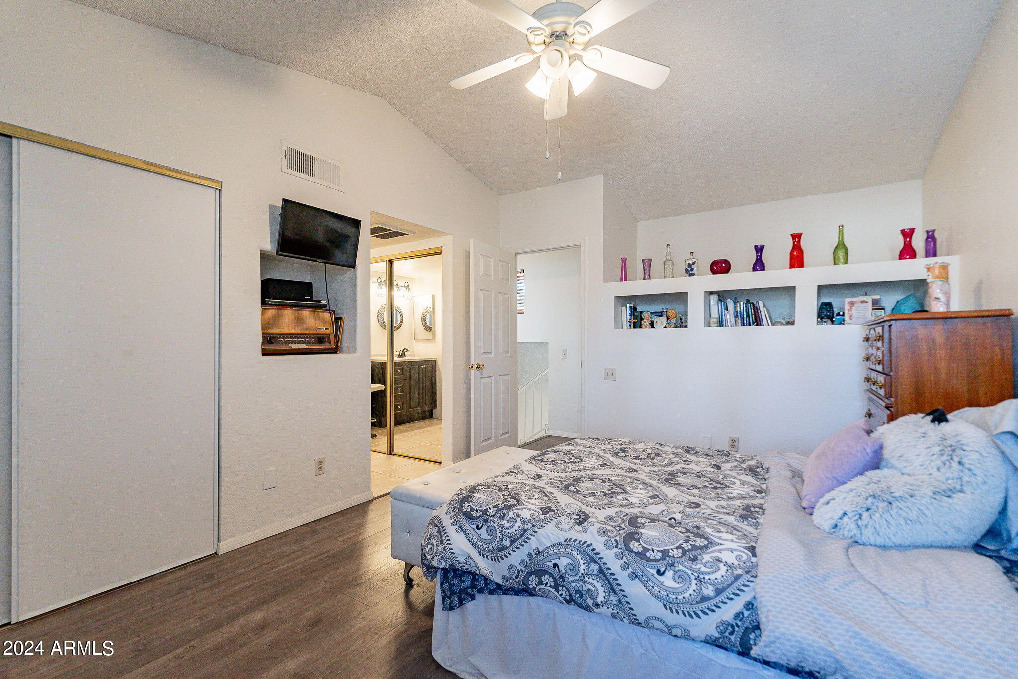 170 East Guadalupe Road, Unit 67 Gilbert, AZ 85234 - Photo 15 of 29 a bedroom with a large bed and a chandelier