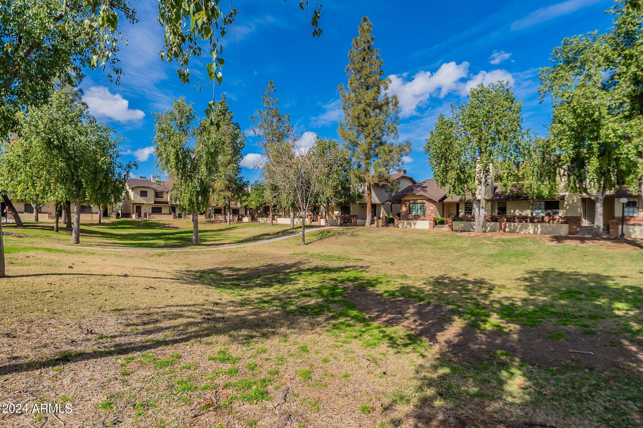 170 East Guadalupe Road, Unit 67 Gilbert, AZ 85234 - Photo 26 of 29 a building with trees in the background