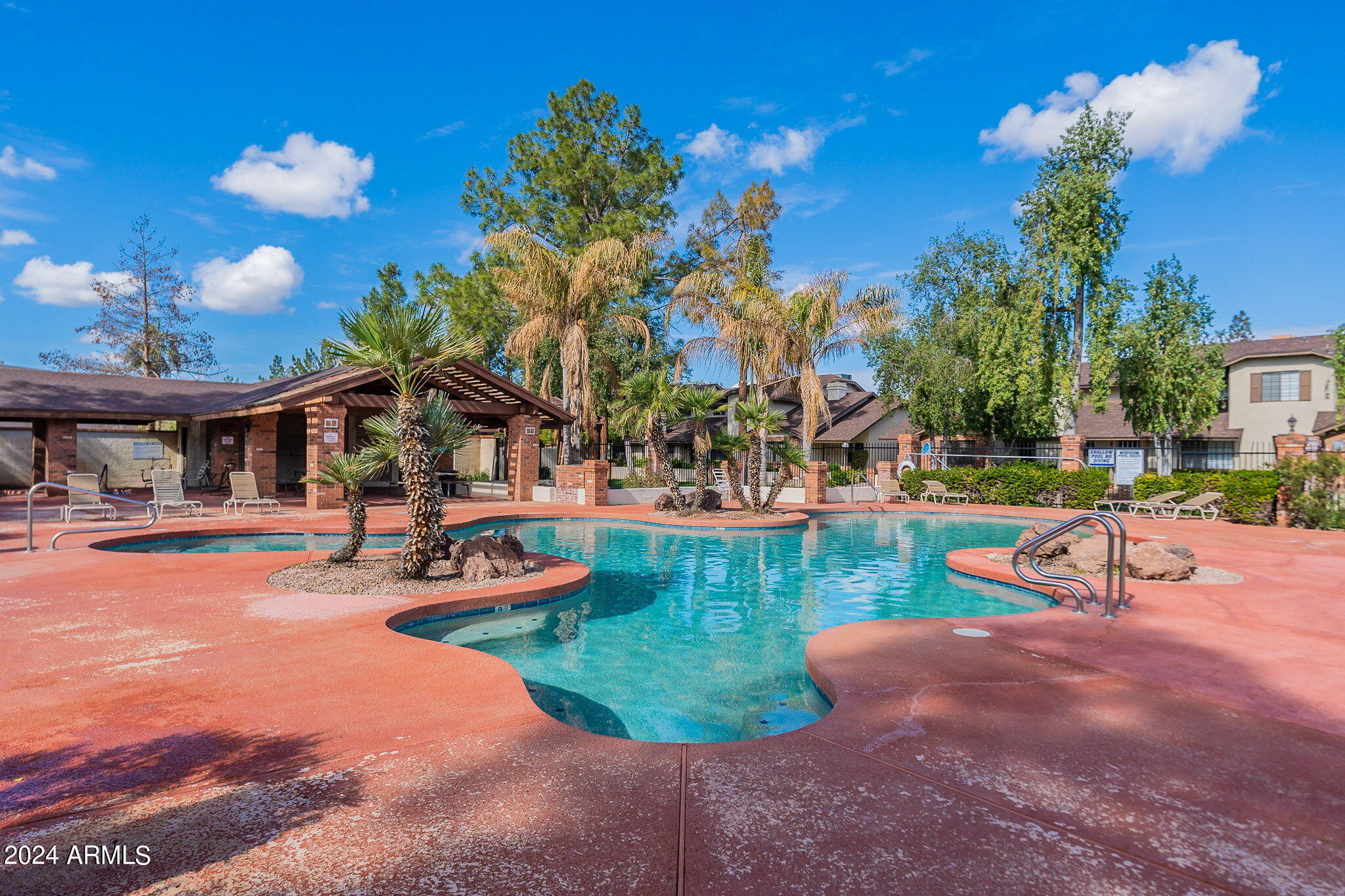 170 East Guadalupe Road, Unit 67 Gilbert, AZ 85234 - Photo 28 of 29 a view of a swimming pool with lounge chairs