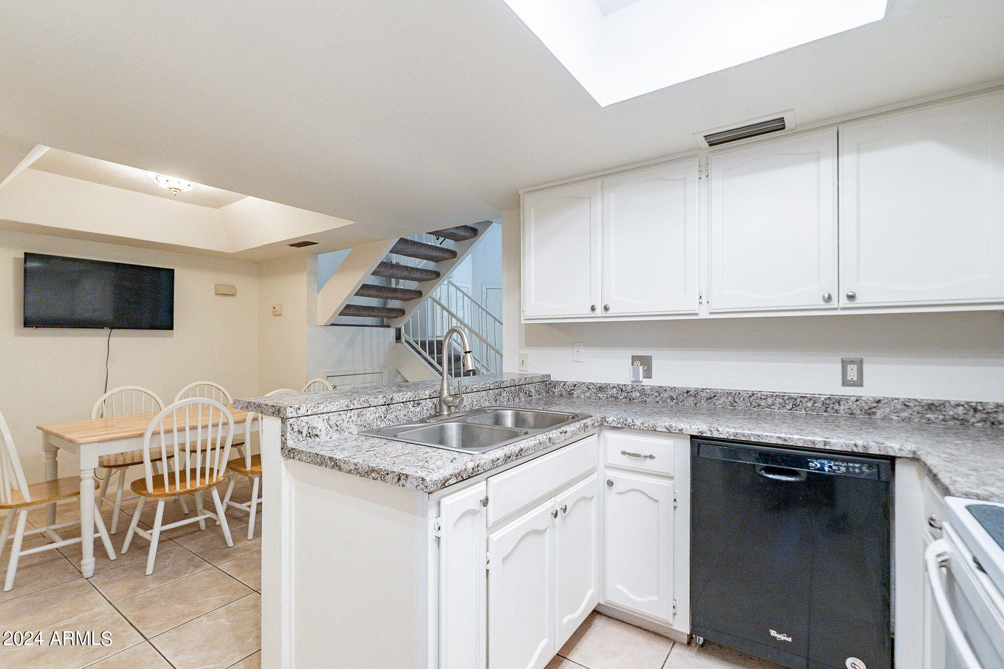 170 East Guadalupe Road, Unit 67 Gilbert, AZ 85234 - Photo 7 of 29 a kitchen with stainless steel appliances granite countertop a sink and a white cabinets