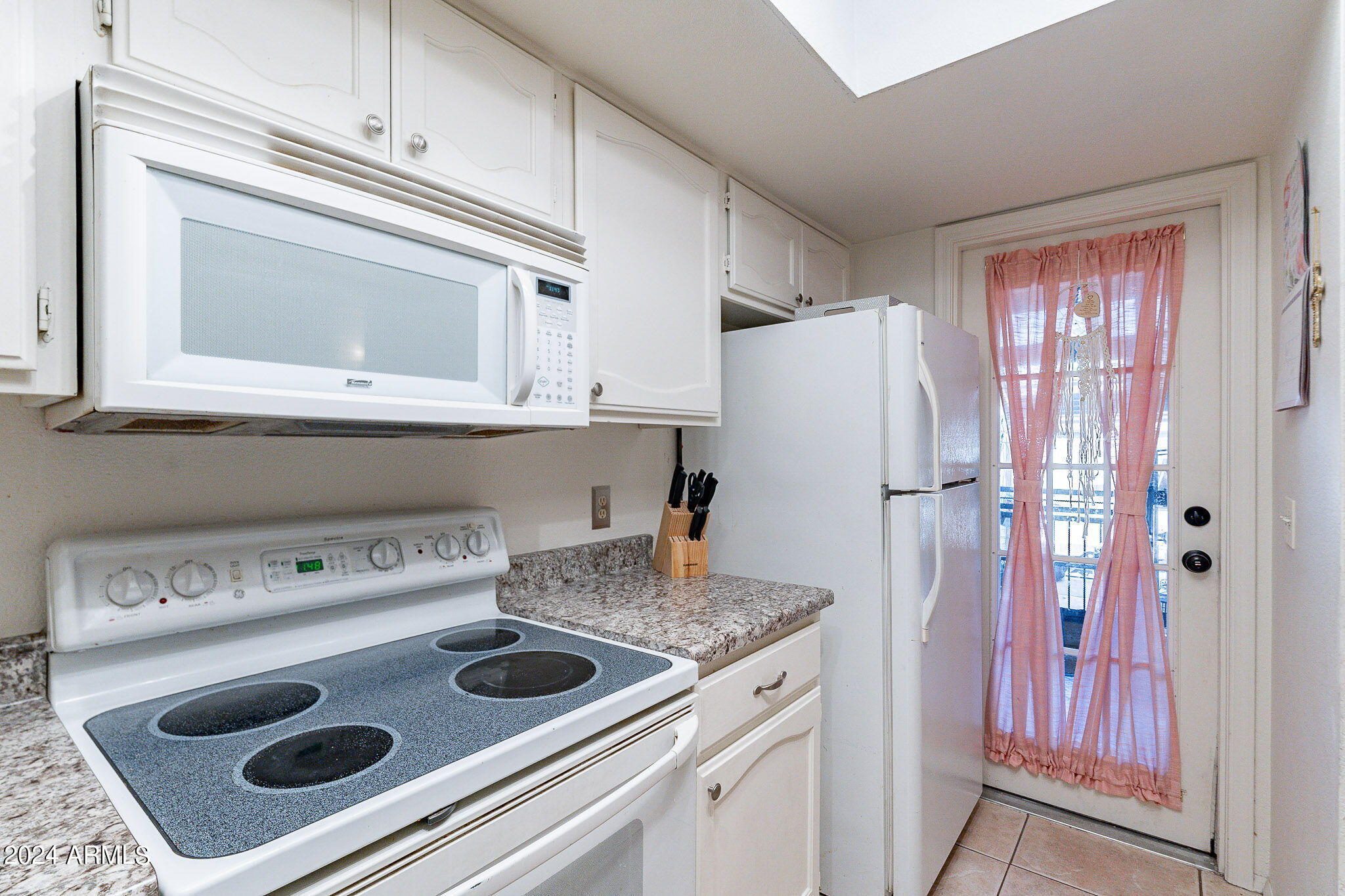 170 East Guadalupe Road, Unit 67 Gilbert, AZ 85234 - Photo 8 of 29 a kitchen with a refrigerator sink and cabinets