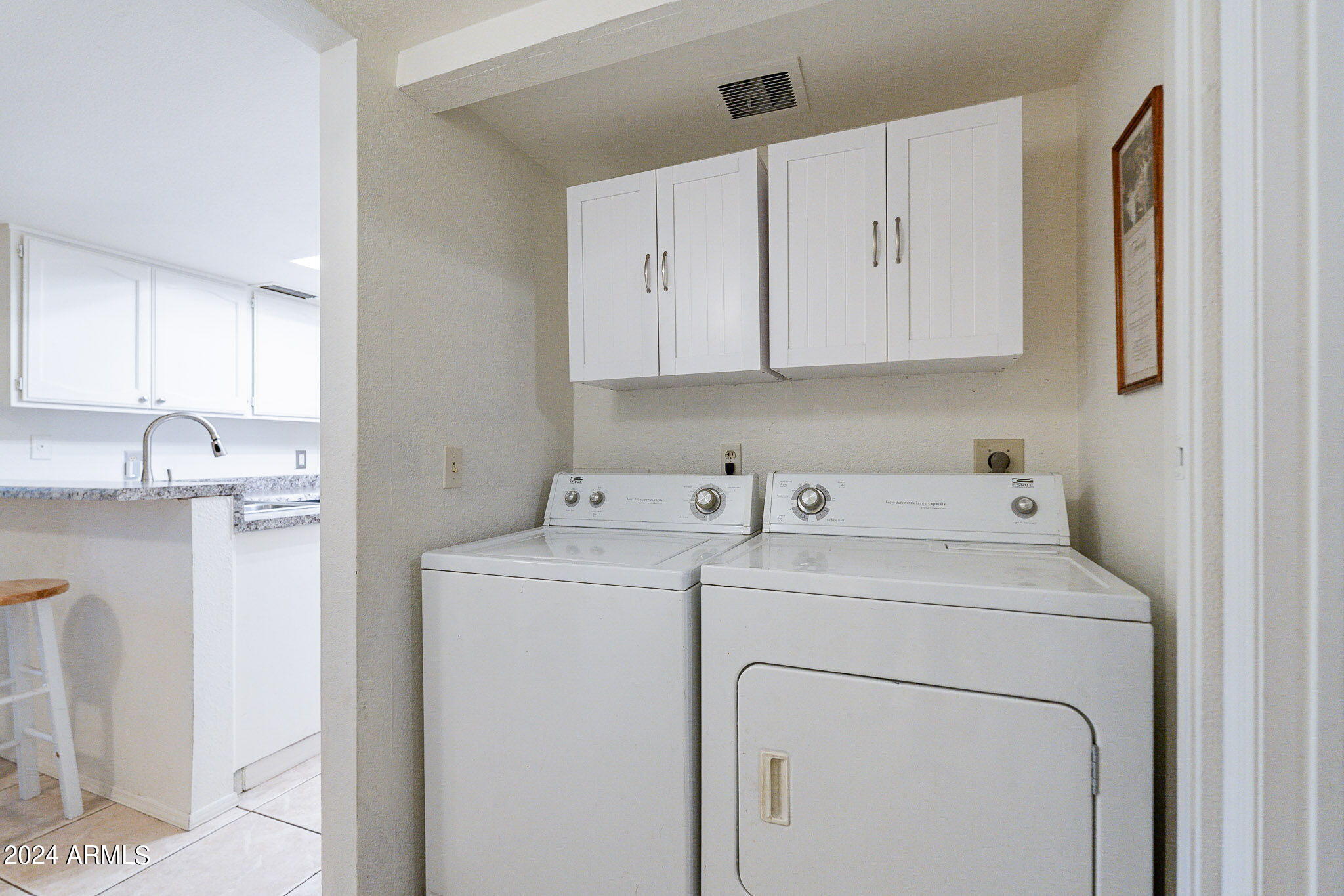 170 East Guadalupe Road, Unit 67 Gilbert, AZ 85234 - Photo 10 of 29 a view of storage and utility room with washer and dryer