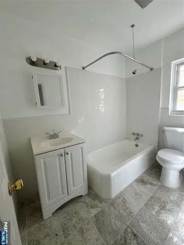 a bathroom with a sink a toilet and bathtub