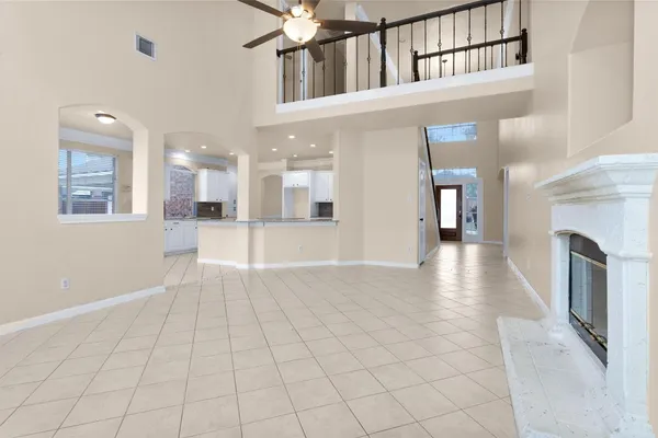 a view of empty room with fireplace and fan