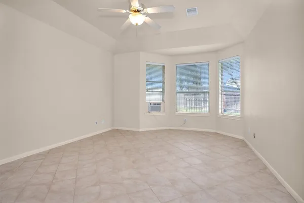 a view of an empty room with a ceiling fan