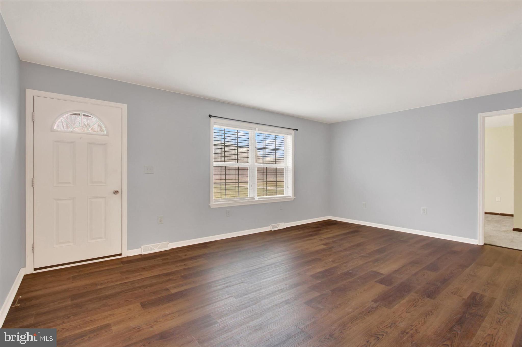 893 Georgetown Road Littlestown, PA 17340 - Photo 4 of 35 a view of an empty room with wooden floor and a window