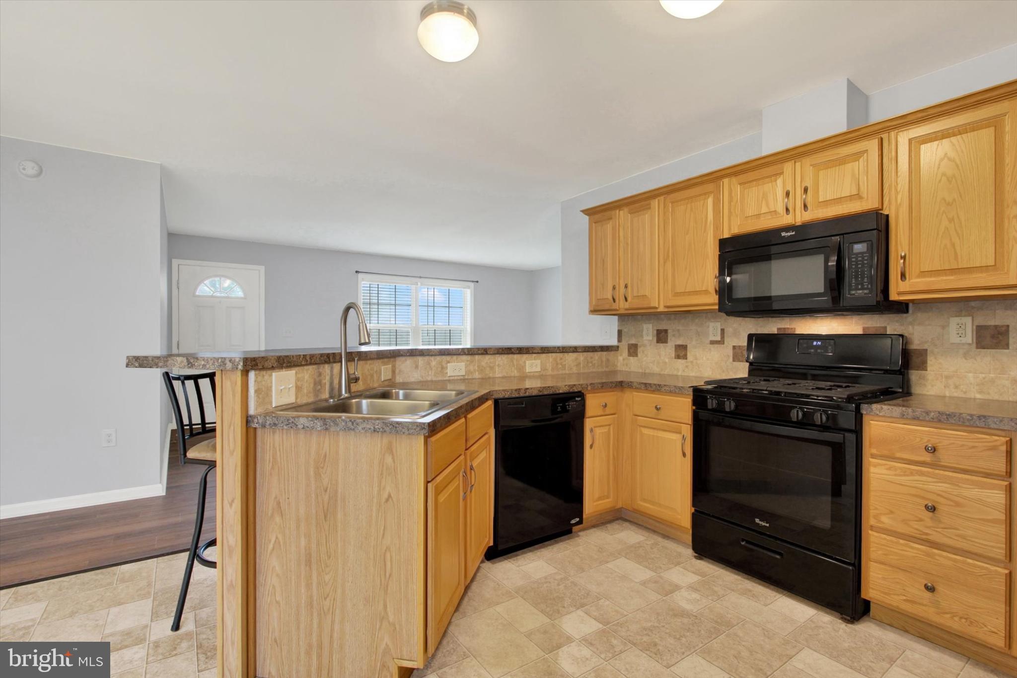 893 Georgetown Road Littlestown, PA 17340 - Photo 9 of 35 a kitchen with stainless steel appliances granite countertop a stove a sink and a microwave