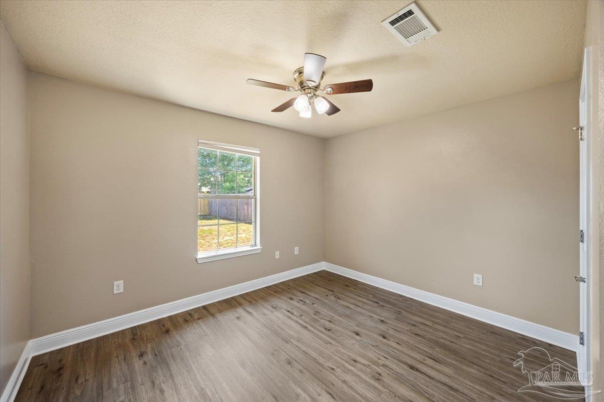 4015 Berry Circle Pace, FL 32571 - Photo 28 of 48 wooden floor in an empty room with a window