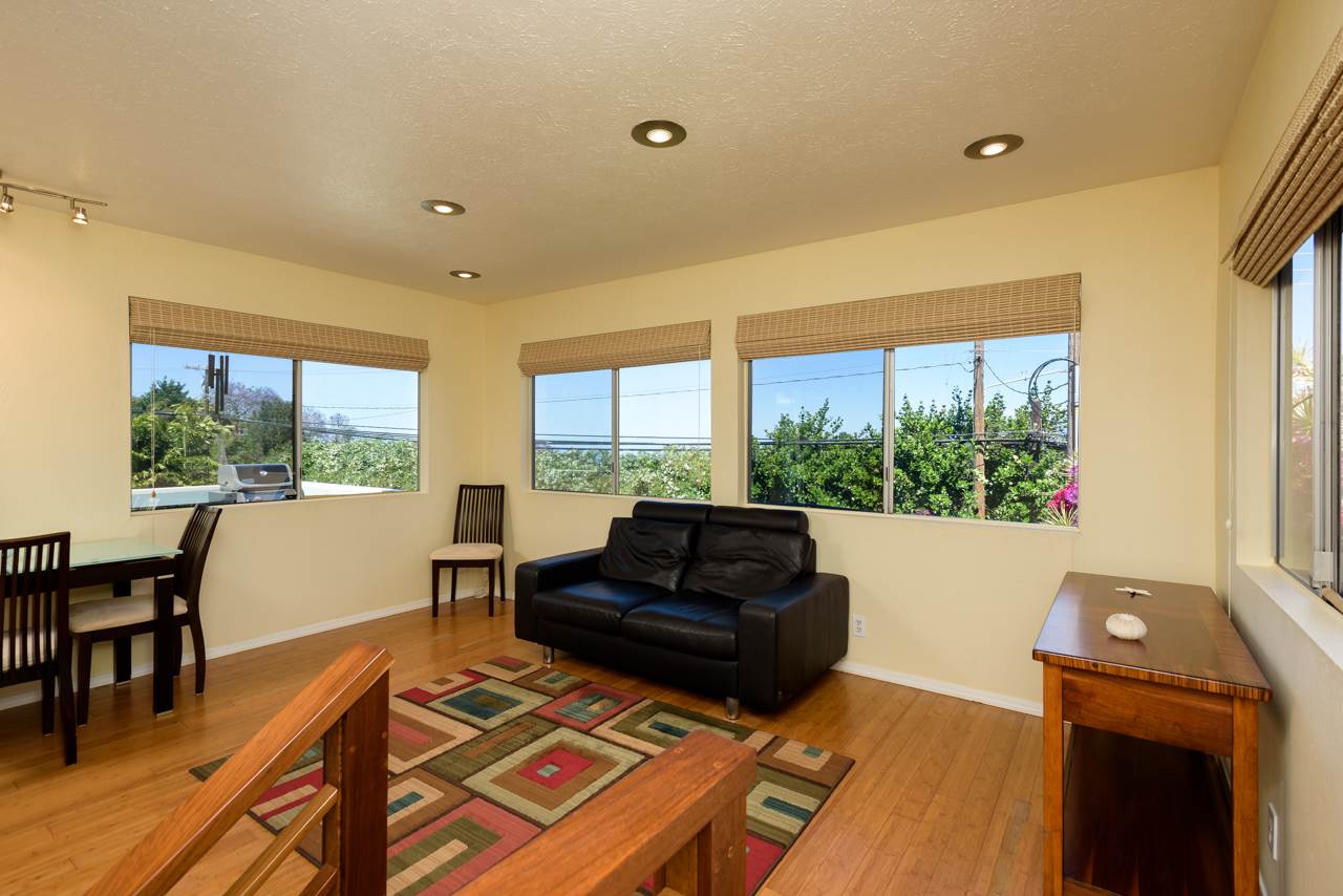 3515 Lower Kula Road Kula, HI 96790 - Photo 13 of 30 a living room with furniture and a floor to ceiling window