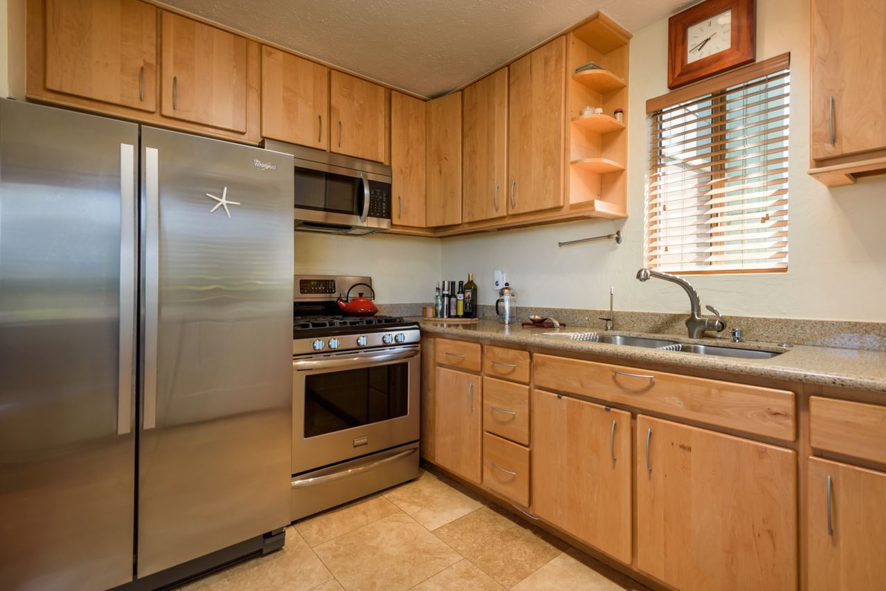 3515 Lower Kula Road Kula, HI 96790 - Photo 17 of 30 a kitchen with stainless steel appliances granite countertop a sink and a refrigerator