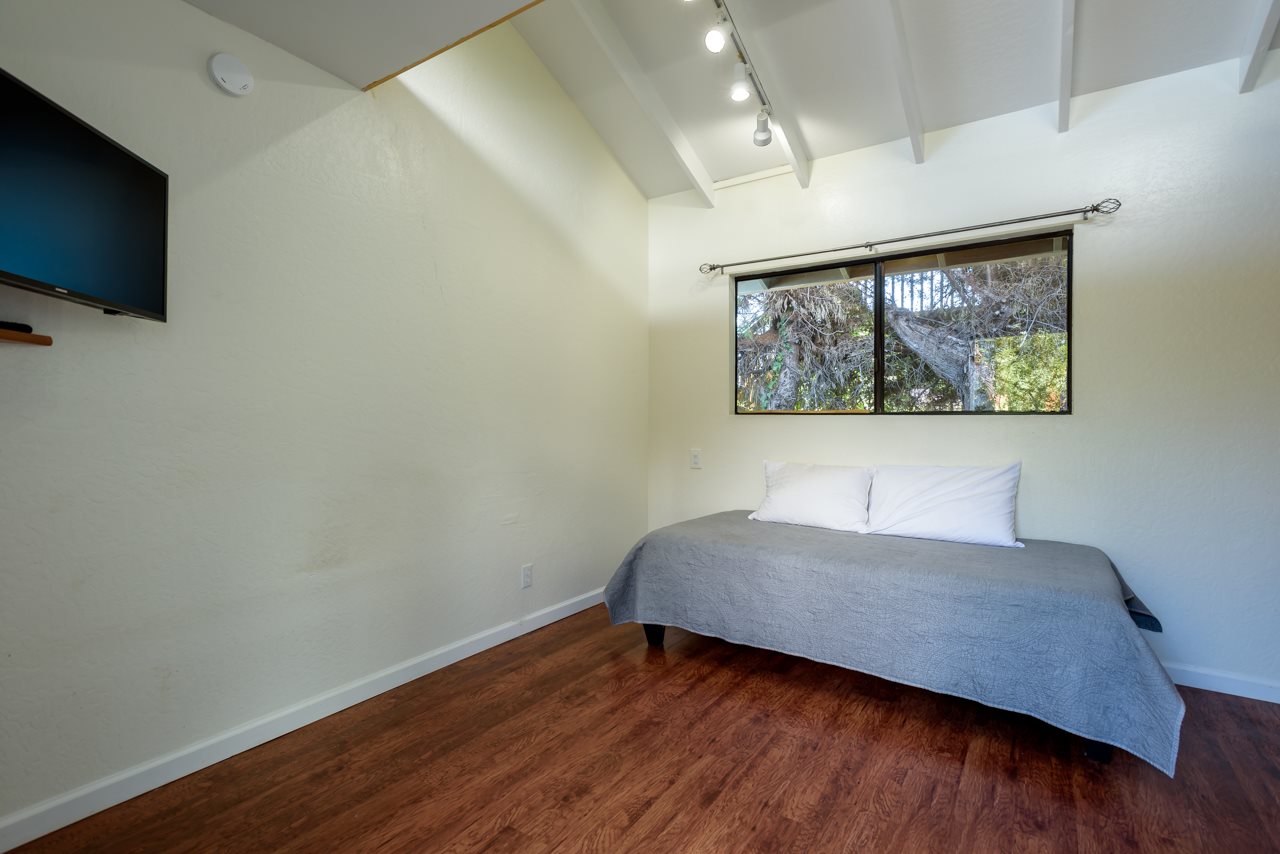 3515 Lower Kula Road Kula, HI 96790 - Photo 20 of 30 a room with a bed and a flat screen tv