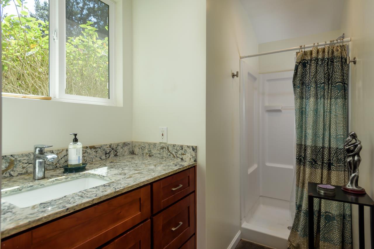 3515 Lower Kula Road Kula, HI 96790 - Photo 22 of 30 a bathroom with a granite countertop sink a vanity and shower