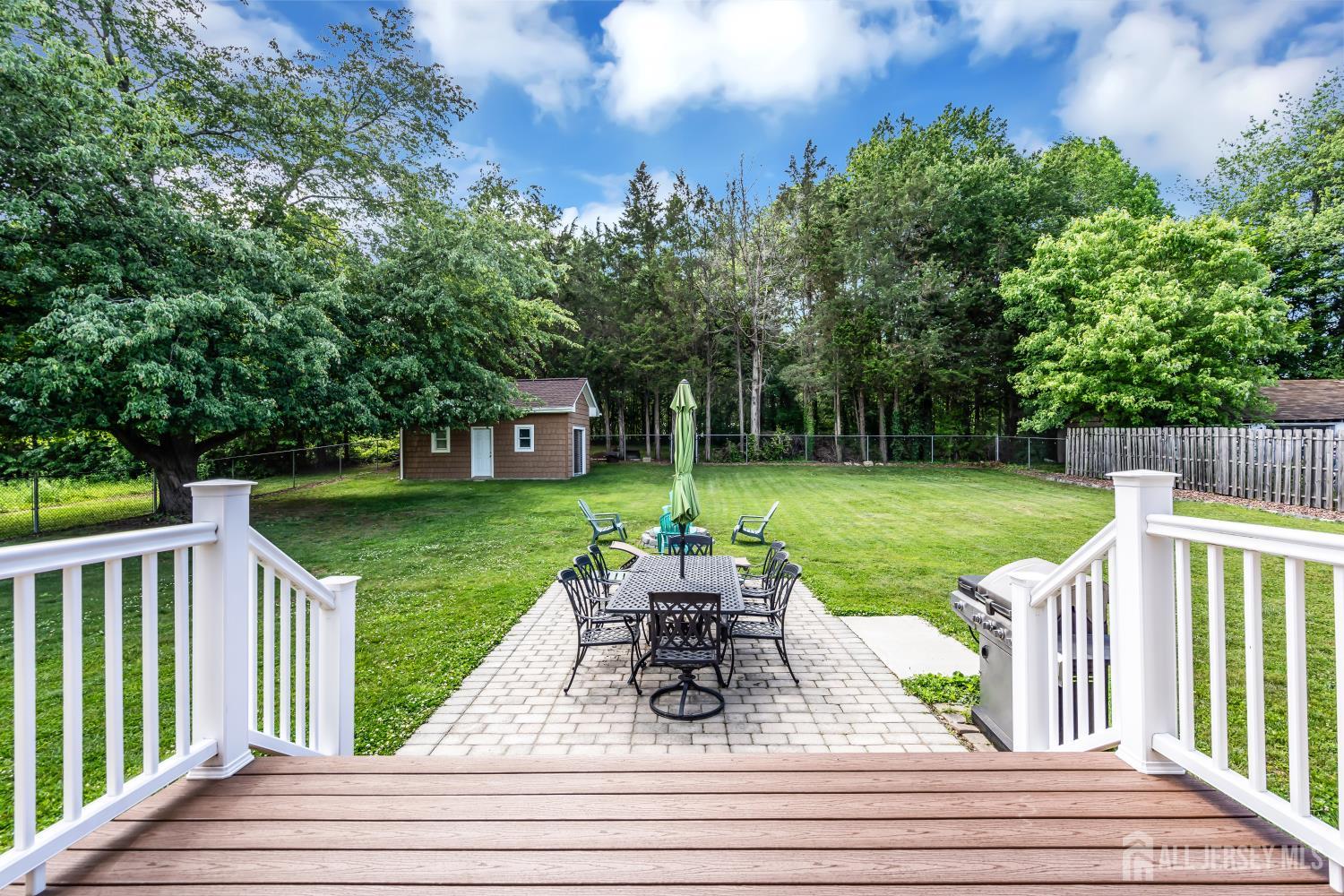99 Schulmeister Road Old Bridge, NJ 08857 - Photo 36 of 49 a view of a patio with table and chairs potted plants and large tree