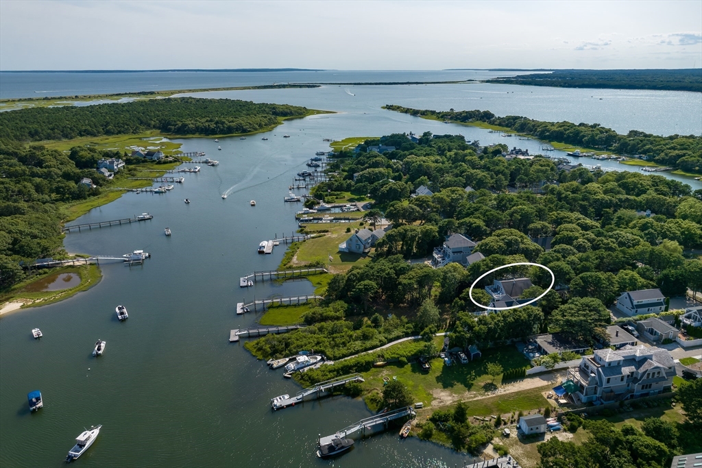 an aerial view of a house a yard and ocean