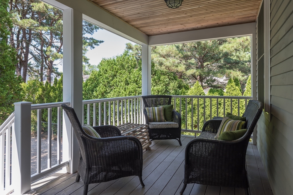 376 Monomoscoy Road Mashpee, MA 02649 - Photo 12 of 31 a view of a chair in wooden deck