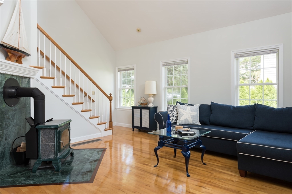 376 Monomoscoy Road Mashpee, MA 02649 - Photo 15 of 31 a living room with furniture and a dining table with wooden floor