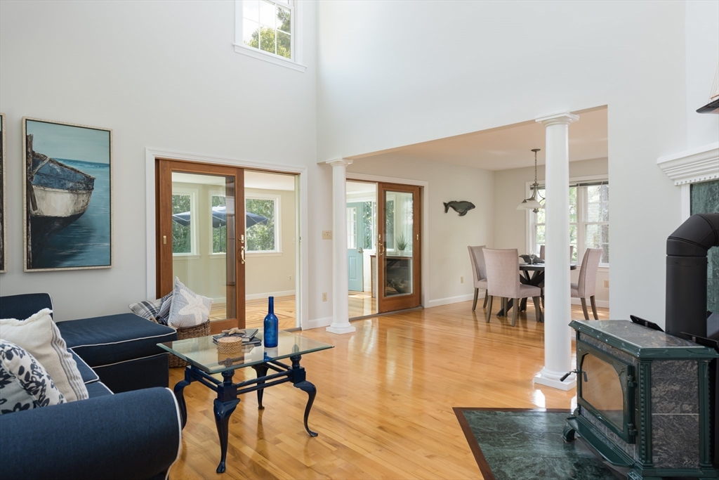 376 Monomoscoy Road Mashpee, MA 02649 - Photo 16 of 31 a living room with furniture a flat screen tv and a table