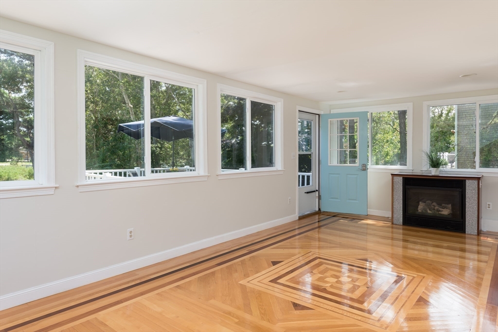 376 Monomoscoy Road Mashpee, MA 02649 - Photo 18 of 31 a view of an empty room with wooden floor and a window