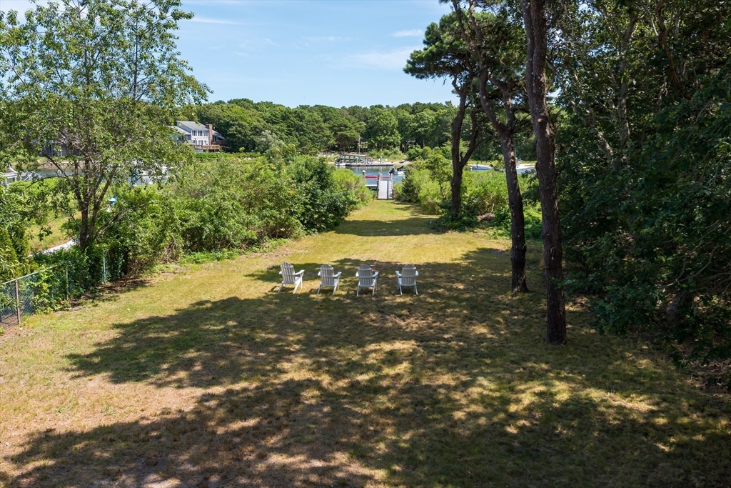 376 Monomoscoy Road Mashpee, MA 02649 - Photo 20 of 31 a view of a yard with trees