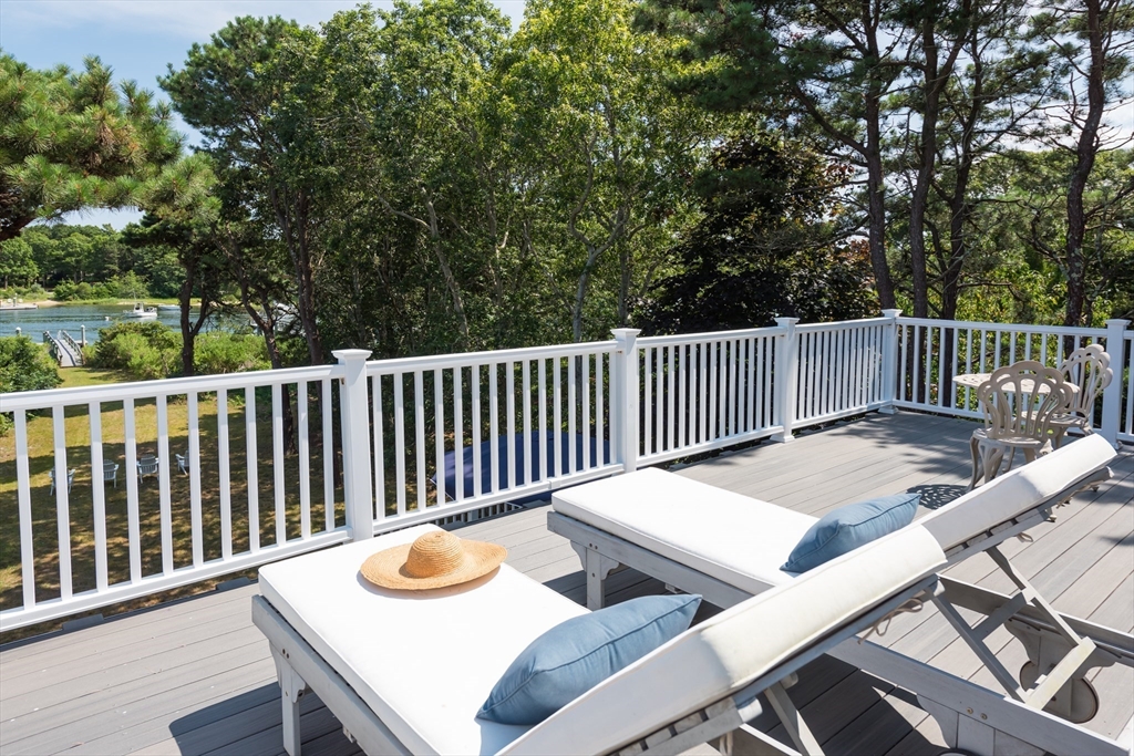376 Monomoscoy Road Mashpee, MA 02649 - Photo 23 of 31 a view of a table and chairs with wooden floor