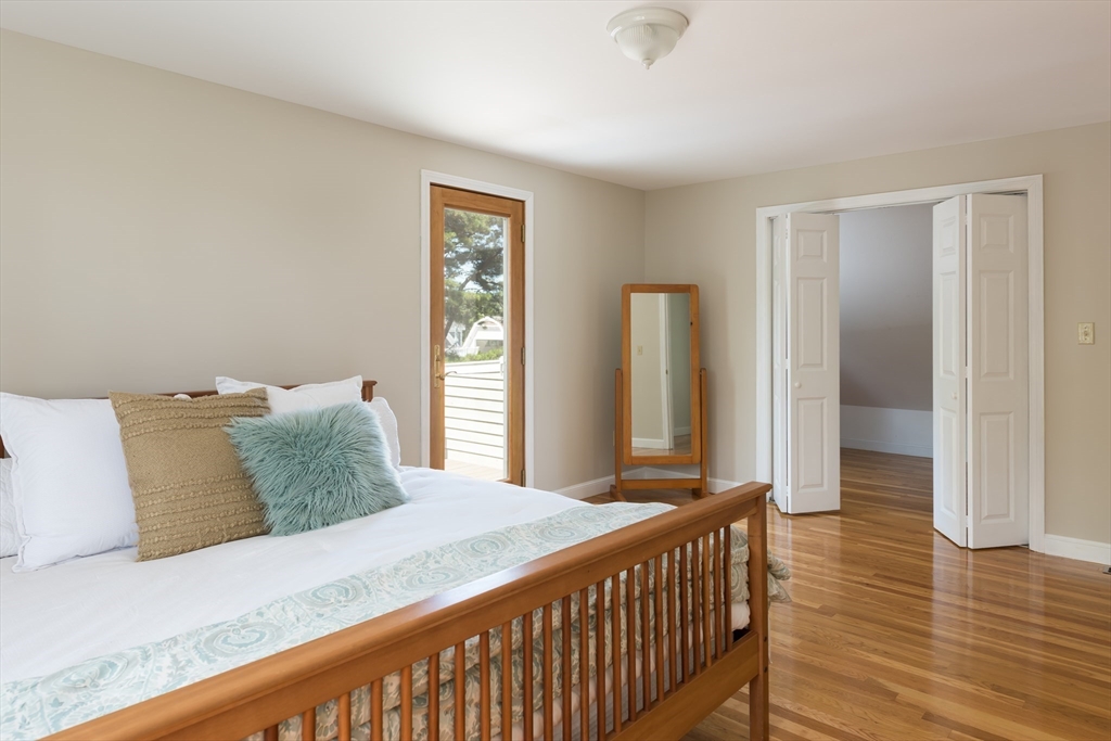 376 Monomoscoy Road Mashpee, MA 02649 - Photo 25 of 31 a bedroom with a bed and a large mirror