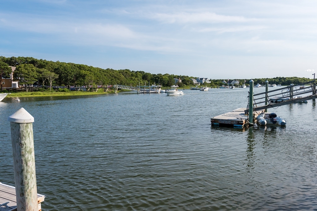 376 Monomoscoy Road Mashpee, MA 02649 - Photo 6 of 31 a view of a lake with houses in the back