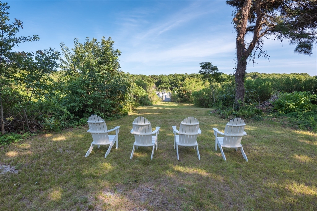 376 Monomoscoy Road Mashpee, MA 02649 - Photo 8 of 31 a view of a chairs and table in the patio
