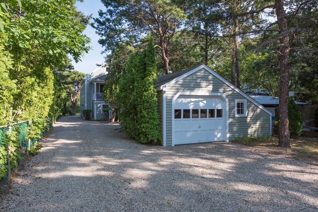 376 Monomoscoy Road Mashpee, MA 02649 - Photo 9 of 31 a front view of a house with a garden
