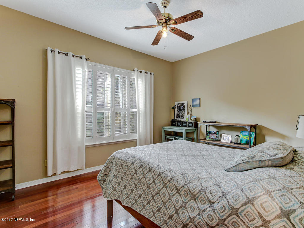 1198 Neck Road Ponte Vedra Beach, FL 32082 - Photo 54 of 101 a bedroom with a bed and wooden floor