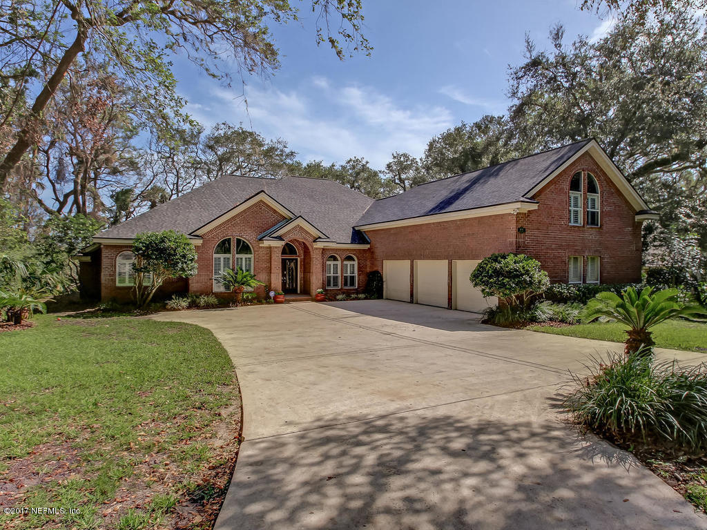 1198 Neck Road Ponte Vedra Beach, FL 32082 - Photo 9 of 101 a front view of a house with a yard and garage