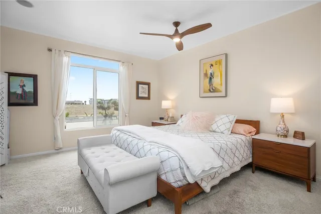 a bedroom with a bed a couch and a window