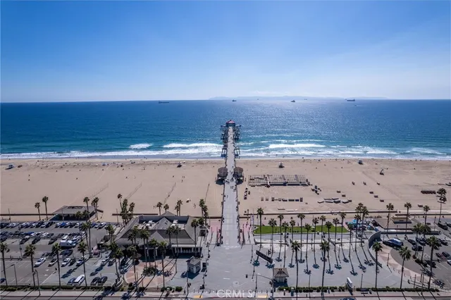 a front view of a house with outdoor space and palm trees