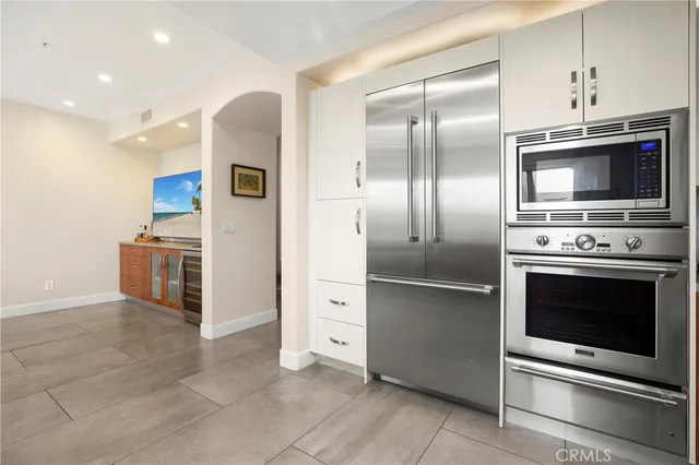 a kitchen with stainless steel appliances granite countertop a refrigerator and a stove